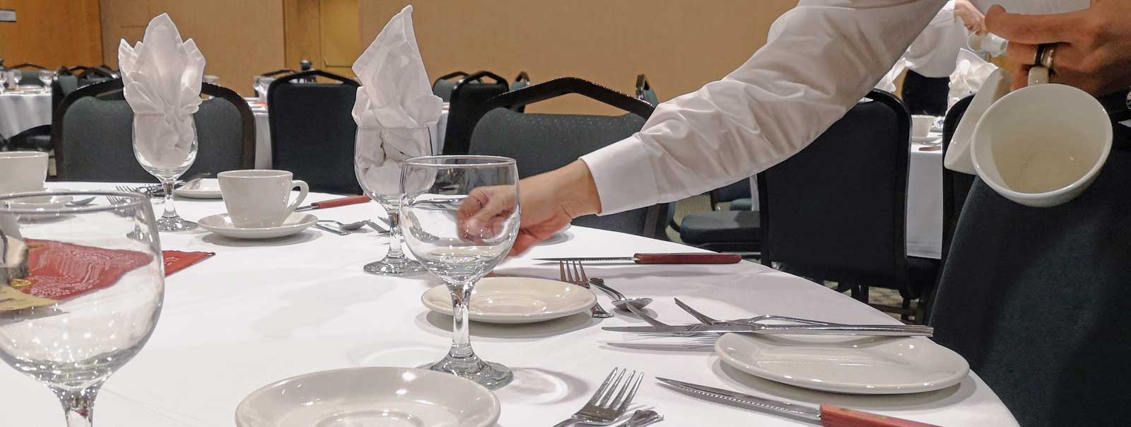 Employé dressant une table de banquet